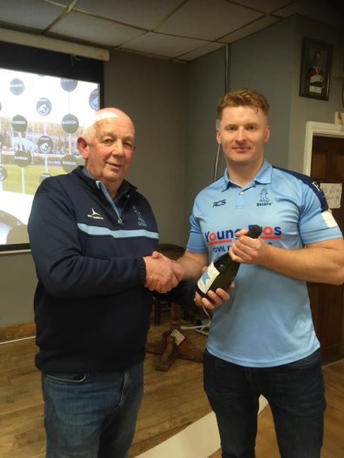 Roy Osborne receives his man of the match award from Bertie Francis
